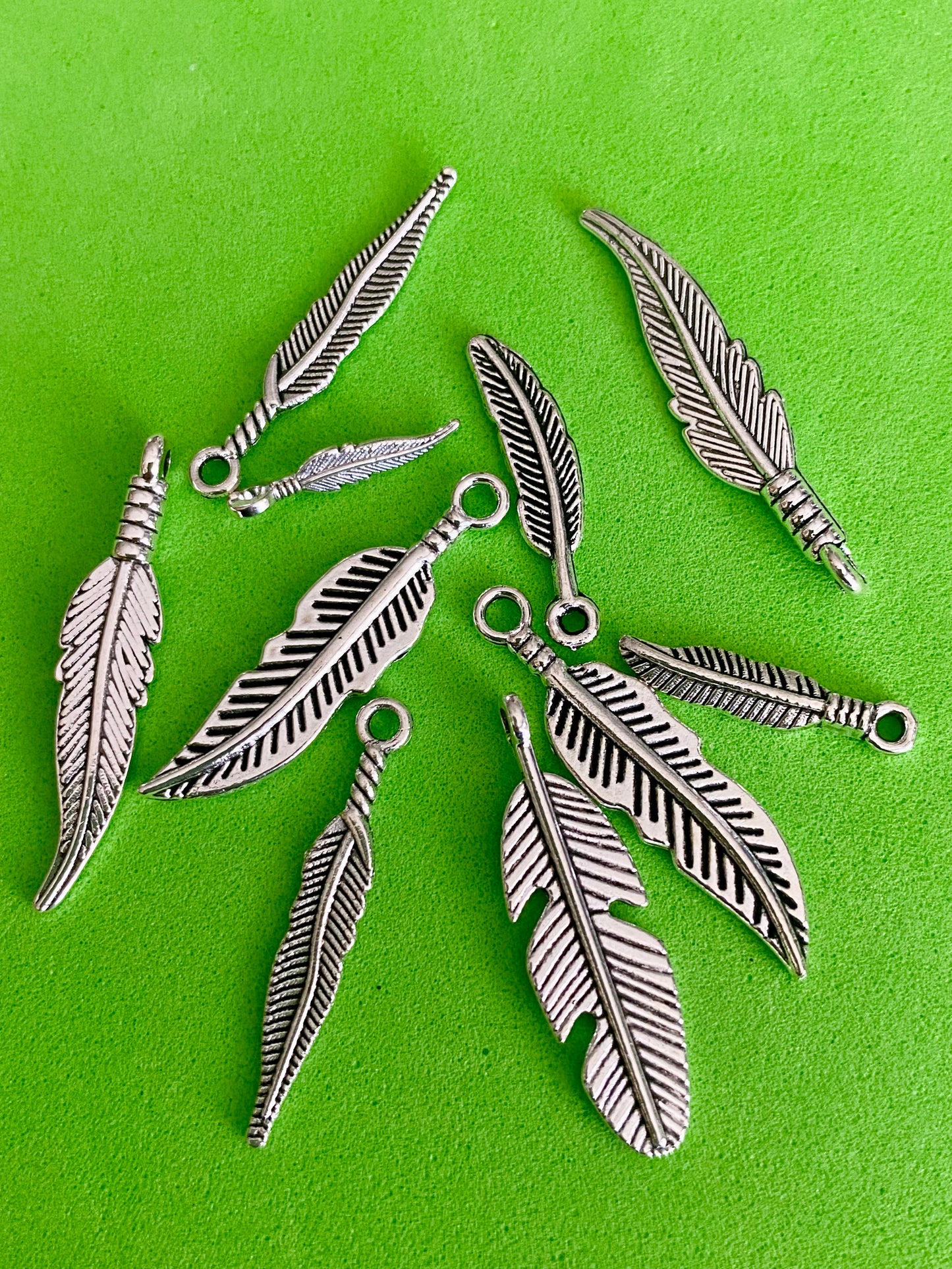 10 x Assorted Sized Silver Coloured Feather Charms