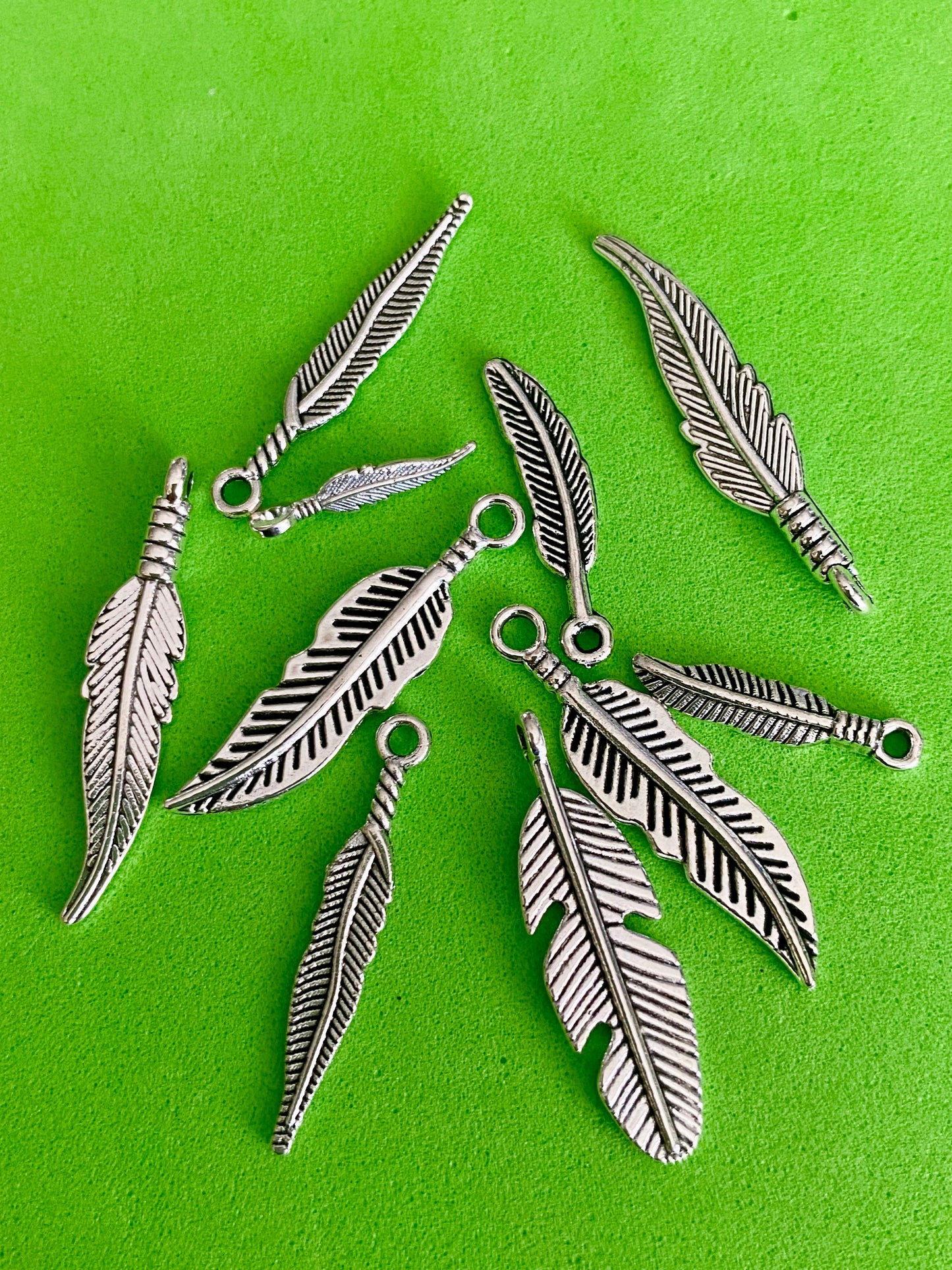 10 x Assorted Sized Silver Coloured Feather Charms